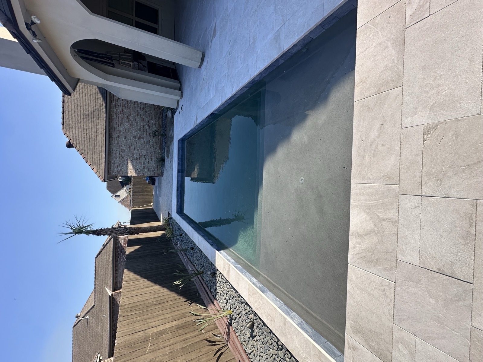 Rectangular pool with clean lines and travertine surround
