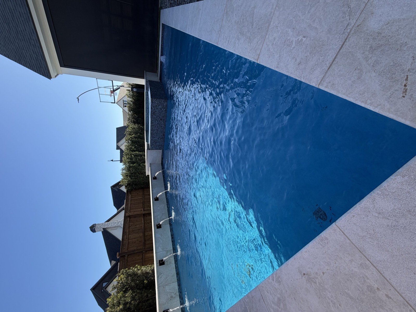 Pool with multiple scuppers and raised spa from wide angle